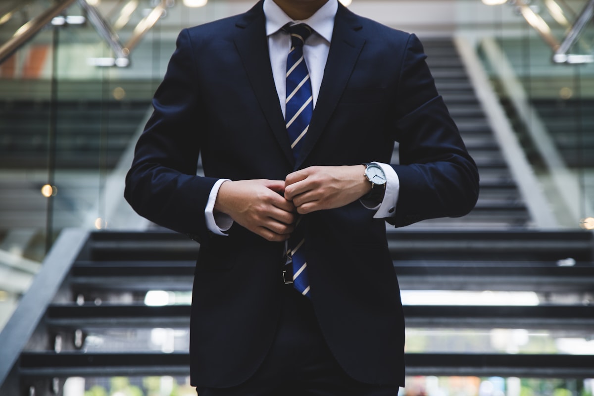 Professional suits and formal wear hanging in dry cleaning facility