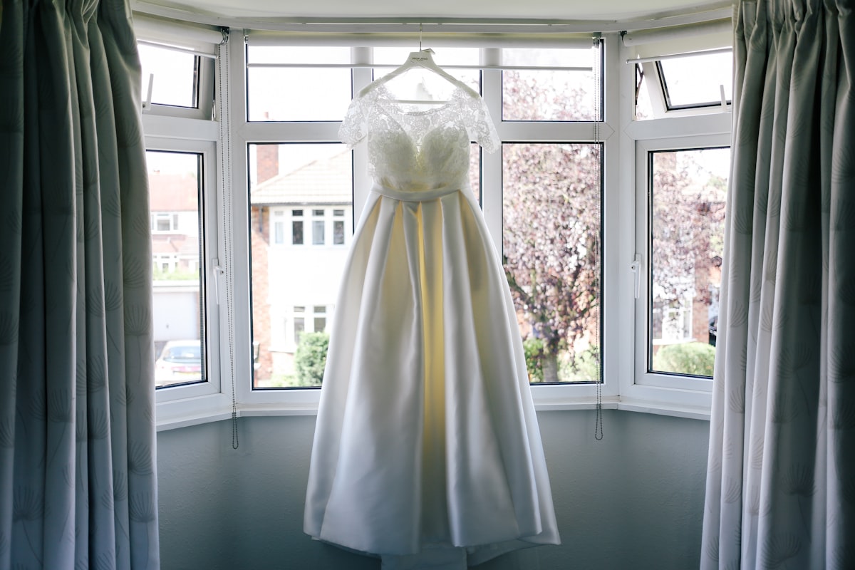 Elegant wedding dress hanging on professional hanger